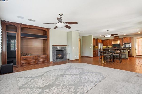 Dining room, Fireplace, Interior, Kitchen, Recessed Lighting, Stainless Steel Appliances, Wood Texture Flooring