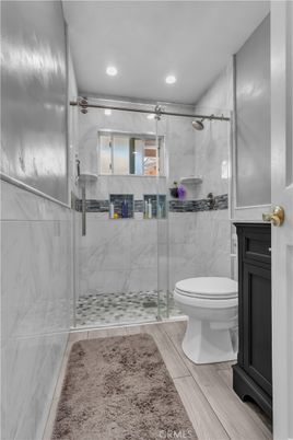 Bathroom, Glass Shower, Interior, Marble Walls, Recessed Lighting, Wood Texture Flooring