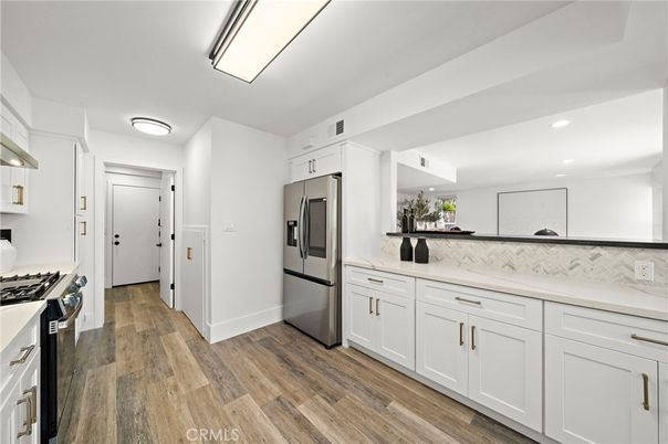 Interior, Kitchen, Marble Walls, Recessed Lighting, Stainless Steel Appliances, Wood Texture Flooring