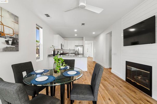 Dining room, Fireplace, Interior, Kitchen, Recessed Lighting, Stainless Steel Appliances, Wood Texture Flooring