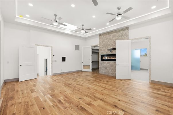 Empty room, Fireplace, Interior, Recessed Lighting, Stone Walls, Wood Texture Flooring