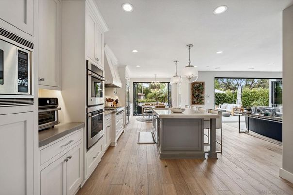 Chandelier, Dining room, Interior, Kitchen, Living room, Pendant Lights, Recessed Lighting, Stainless Steel Appliances, Wood Texture Flooring