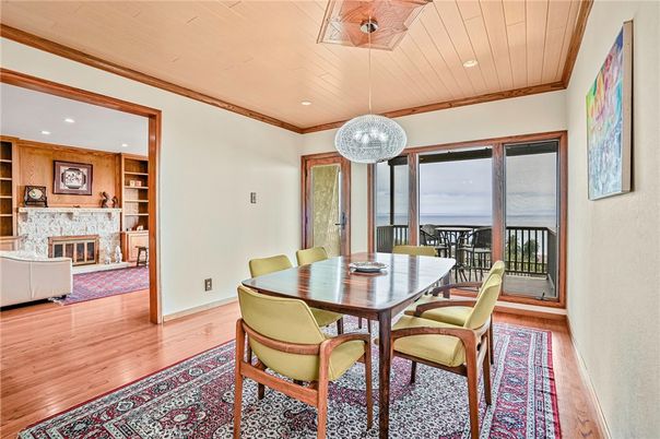 Dining room, Fireplace, Interior, Pendant Lights, Recessed Lighting, Water, Wood Texture Flooring