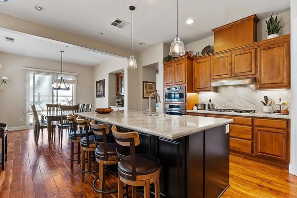 Dining room, Interior, Kitchen, Pendant Lights, Recessed Lighting, Stainless Steel Appliances, Wood Texture Flooring
