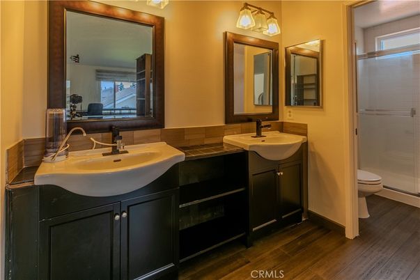 Bathroom, Dual Sink Vanities, Glass Shower, Interior, Tile Countertops, Wood Texture Flooring