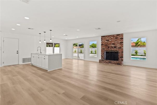 Empty room, Fireplace, Interior, Kitchen, Pendant Lights, Recessed Lighting, Stone Walls, Wood Texture Flooring