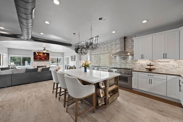 Fireplace, Interior, Kitchen, Living room, Pendant Lights, Recessed Lighting, Stainless Steel Appliances, Stone Walls, Wood Texture Flooring