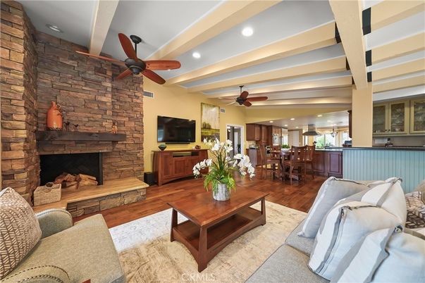 Dining room, Fireplace, Interior, Living room, Recessed Lighting, Stone Walls, Wood Texture Flooring