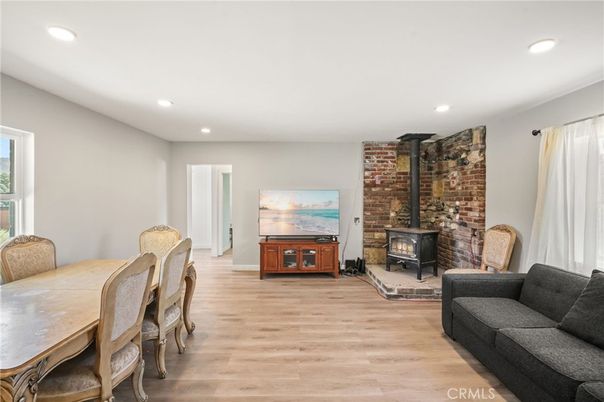 Dining room, Fireplace, Interior, Living room, Recessed Lighting, Stone Walls, Wood Texture Flooring