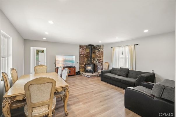 Dining room, Fireplace, Interior, Living room, Recessed Lighting, Stone Walls, Wood Texture Flooring