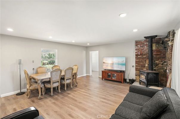 Dining room, Fireplace, Interior, Living room, Recessed Lighting, Stone Walls, Wood Texture Flooring