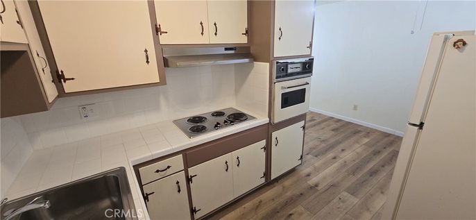 Interior, Kitchen, Stainless Steel Appliances, Tile Countertops, Wood Texture Flooring