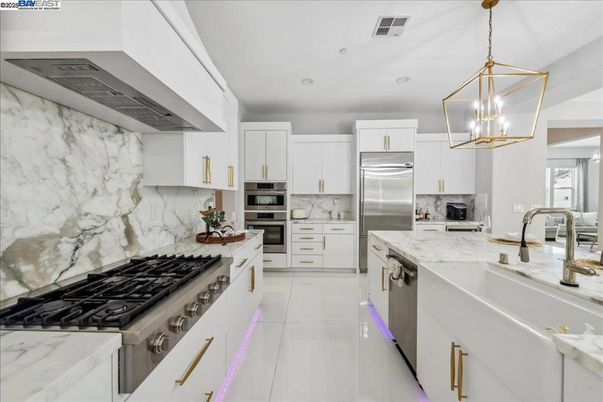 Interior, Kitchen, Marble Walls, Pendant Lights, Recessed Lighting, Stainless Steel Appliances