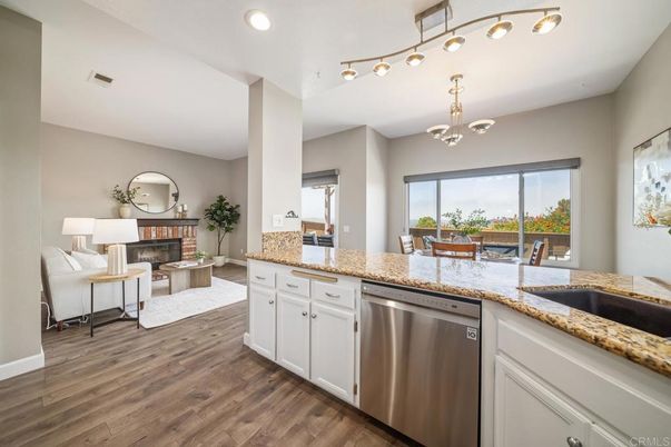 Chandelier, Fireplace, Interior, Kitchen, Living room, Recessed Lighting, Wood Texture Flooring