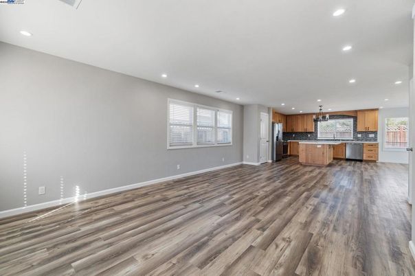 Empty room, Interior, Kitchen, Pendant Lights, Recessed Lighting, Stainless Steel Appliances, Wood Texture Flooring