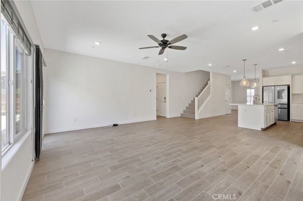 Empty room, Interior, Kitchen, Pendant Lights, Recessed Lighting, Stainless Steel Appliances, Wood Texture Flooring