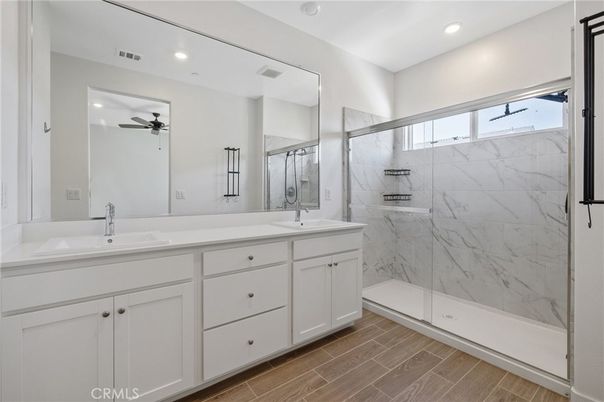 Bathroom, Dual Sink Vanities, Glass Shower, Interior, Marble Walls, Recessed Lighting, Wood Texture Flooring