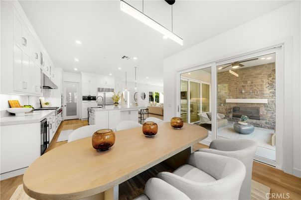 Dining room, Fireplace, Interior, Kitchen, Pendant Lights, Recessed Lighting, Stainless Steel Appliances, Stone Walls, Wood Texture Flooring