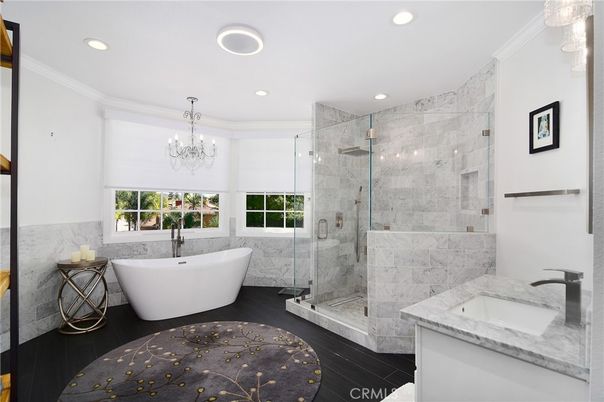 Bathroom, Chandelier, Free Standing Baths, Glass Shower, Interior, Marble Walls, Recessed Lighting, Wood Texture Flooring