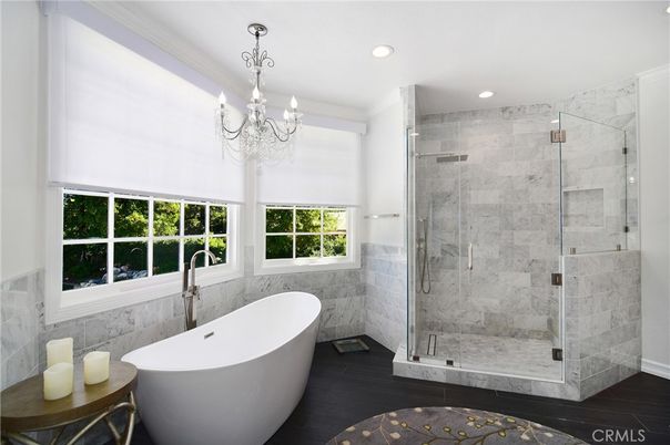 Bathroom, Chandelier, Free Standing Baths, Glass Shower, Interior, Marble Walls, Recessed Lighting, Wood Texture Flooring