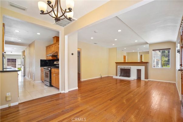 Chandelier, Empty room, Fireplace, Interior, Kitchen, Recessed Lighting, Wood Texture Flooring