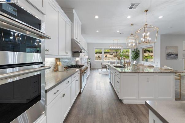 Chandelier, Dining room, Interior, Kitchen, Pendant Lights, Recessed Lighting, Stainless Steel Appliances, Wood Texture Flooring