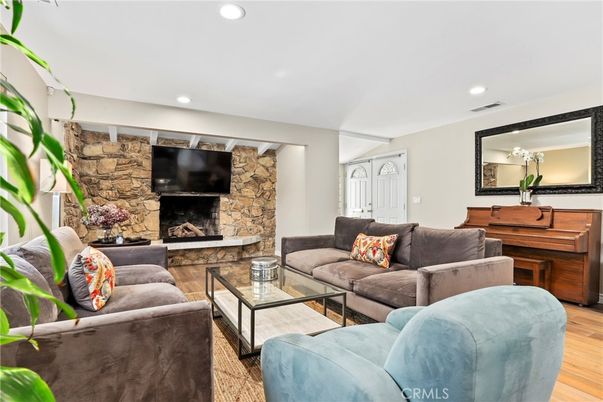 Fireplace, Interior, Living room, Piano, Recessed Lighting, Stone Walls, Wood Texture Flooring