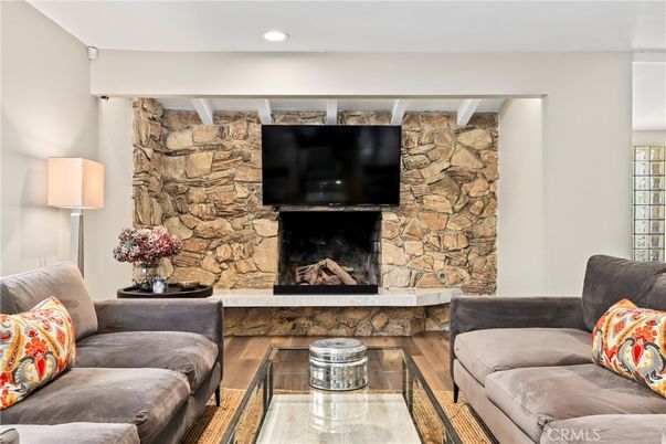Fireplace, Interior, Living room, Recessed Lighting, Stone Walls, Wood Texture Flooring