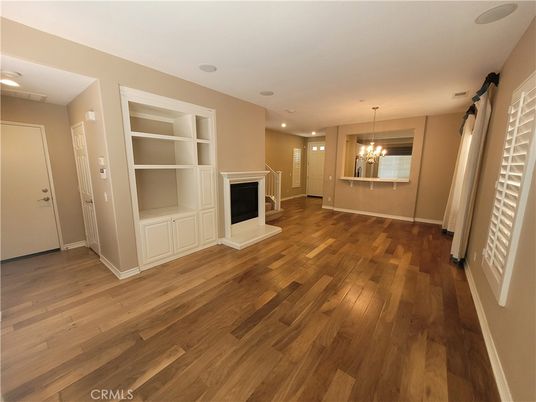 Chandelier, Empty room, Fireplace, Interior, Recessed Lighting, Wood Texture Flooring