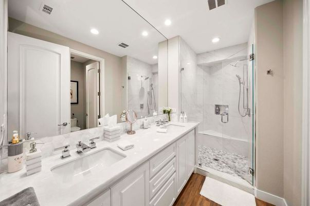 Bathroom, Dual Sink Vanities, Glass Shower, Interior, Marble Walls, Recessed Lighting, Wood Texture Flooring