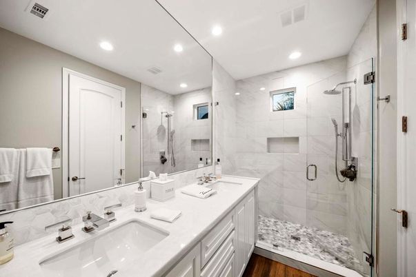 Bathroom, Dual Sink Vanities, Glass Shower, Interior, Marble Walls, Recessed Lighting, Wood Texture Flooring