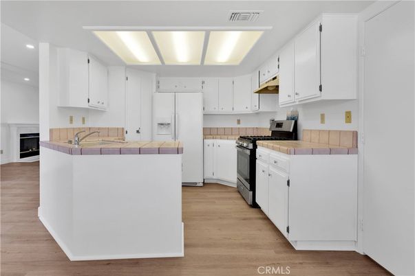 Interior, Kitchen, Recessed Lighting, Tile Countertops, Wood Texture Flooring