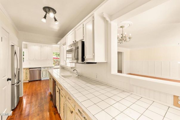 Chandelier, Interior, Kitchen, Stainless Steel Appliances, Tile Countertops, Wood Texture Flooring