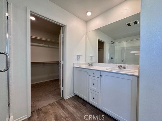 Bathroom, Dual Sink Vanities, Glass Shower, Interior, Recessed Lighting, Walk-in Closets, Wood Texture Flooring