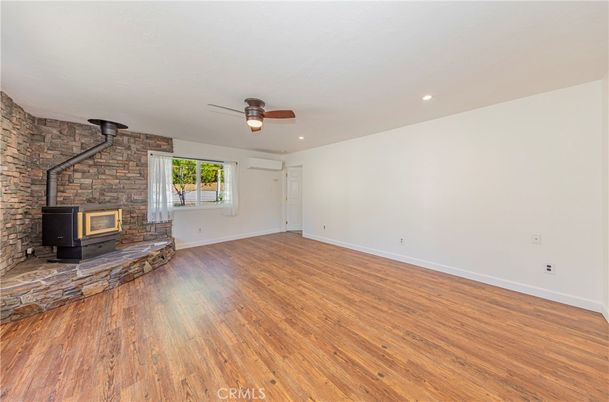 Empty room, Fireplace, Interior, Recessed Lighting, Stone Walls, Wood Texture Flooring