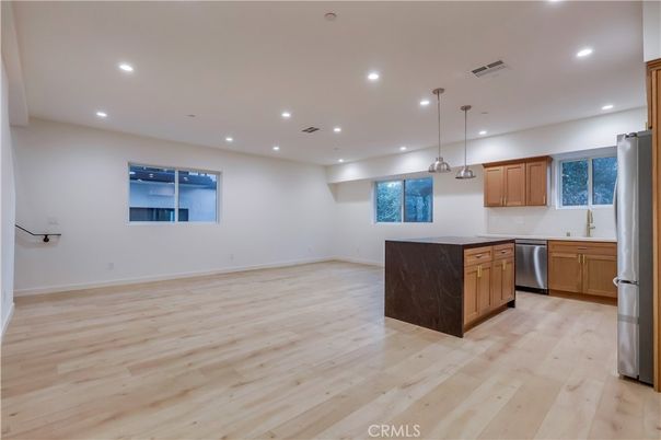 Empty room, Interior, Kitchen, Pendant Lights, Recessed Lighting, Stainless Steel Appliances, Wood Texture Flooring