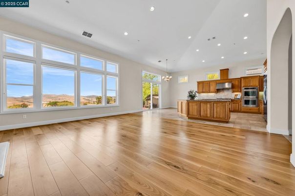 Chandelier, Empty room, Interior, Kitchen, Pendant Lights, Recessed Lighting, Stainless Steel Appliances, Wood Texture Flooring