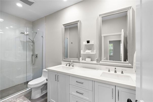 Bathroom, Dual Sink Vanities, Glass Shower, Interior, Recessed Lighting, Wood Texture Flooring
