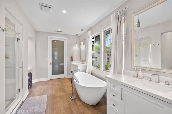 Bathroom, Dual Sink Vanities, Free Standing Baths, Glass Shower, Interior, Pendant Lights, Recessed Lighting, Wood Texture Flooring
