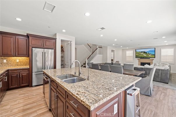 Dining room, Fireplace, Interior, Kitchen, Living room, Recessed Lighting, Stainless Steel Appliances, Wood Texture Flooring