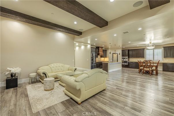 Chandelier, Dining room, Interior, Kitchen, Living room, Pendant Lights, Recessed Lighting, Stainless Steel Appliances, Wooden Beams, Wood Texture Flooring