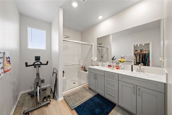 Bathroom, Dual Sink Vanities, Fitness Equipment, Glass Shower, Interior, Recessed Lighting, Wood Texture Flooring