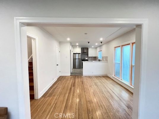 Empty room, Interior, Kitchen, Recessed Lighting, Stainless Steel Appliances, Wood Texture Flooring