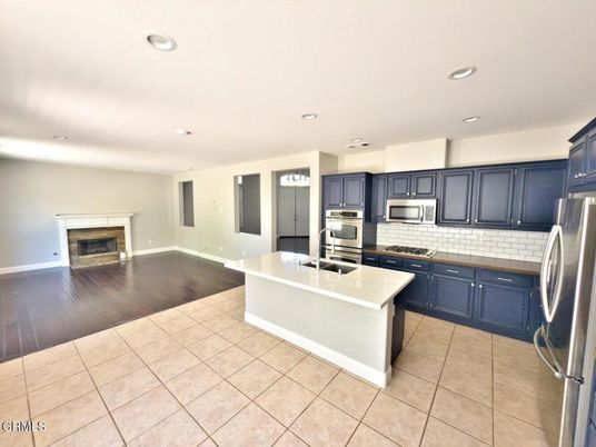 Fireplace, Interior, Kitchen, Recessed Lighting, Stainless Steel Appliances, Wood Texture Flooring
