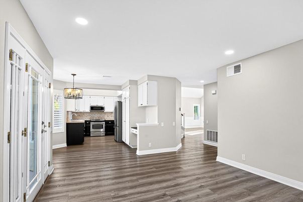 Chandelier, Empty room, Interior, Kitchen, Pendant Lights, Recessed Lighting, Stainless Steel Appliances, Wood Texture Flooring