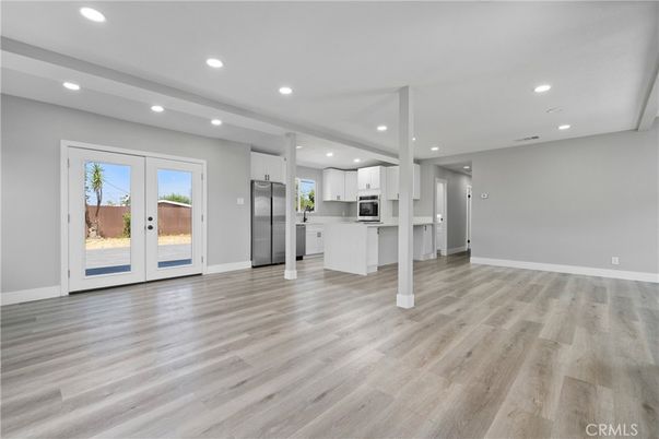 Empty room, Interior, Kitchen, Recessed Lighting, Stainless Steel Appliances, Wood Texture Flooring