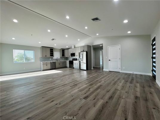 Empty room, Interior, Kitchen, Recessed Lighting, Stainless Steel Appliances, Wood Texture Flooring