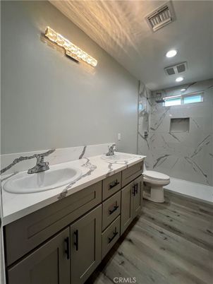 Bathroom, Dual Sink Vanities, Interior, Marble Walls, Recessed Lighting, Wood Texture Flooring