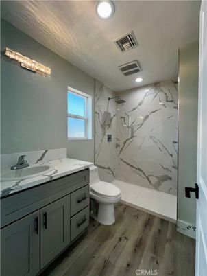 Bathroom, Dual Sink Vanities, Interior, Marble Walls, Recessed Lighting, Wood Texture Flooring