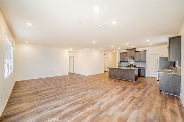 Empty room, Interior, Kitchen, Recessed Lighting, Stainless Steel Appliances, Wood Texture Flooring